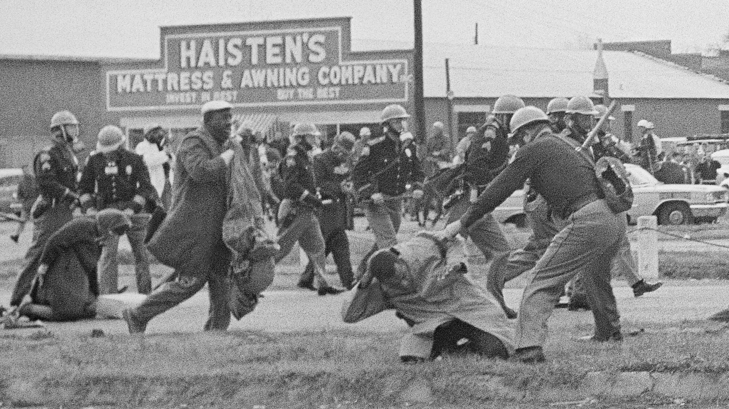 State troopers swinging billy clubs to break up a civil rights voting march in Selma, Ala., March 7, 1965. John Lewis and Hosea Williams lead approximately 600 people planning to march to Montgomery who are stopped as they try to cross the Edmund Pettus Bridge leading out of Selma. TV cameras broadcast the assault in what became known as "Bloody Sunday" with demonstrations across the country over the next two days supporting the marchers. - Associated Press