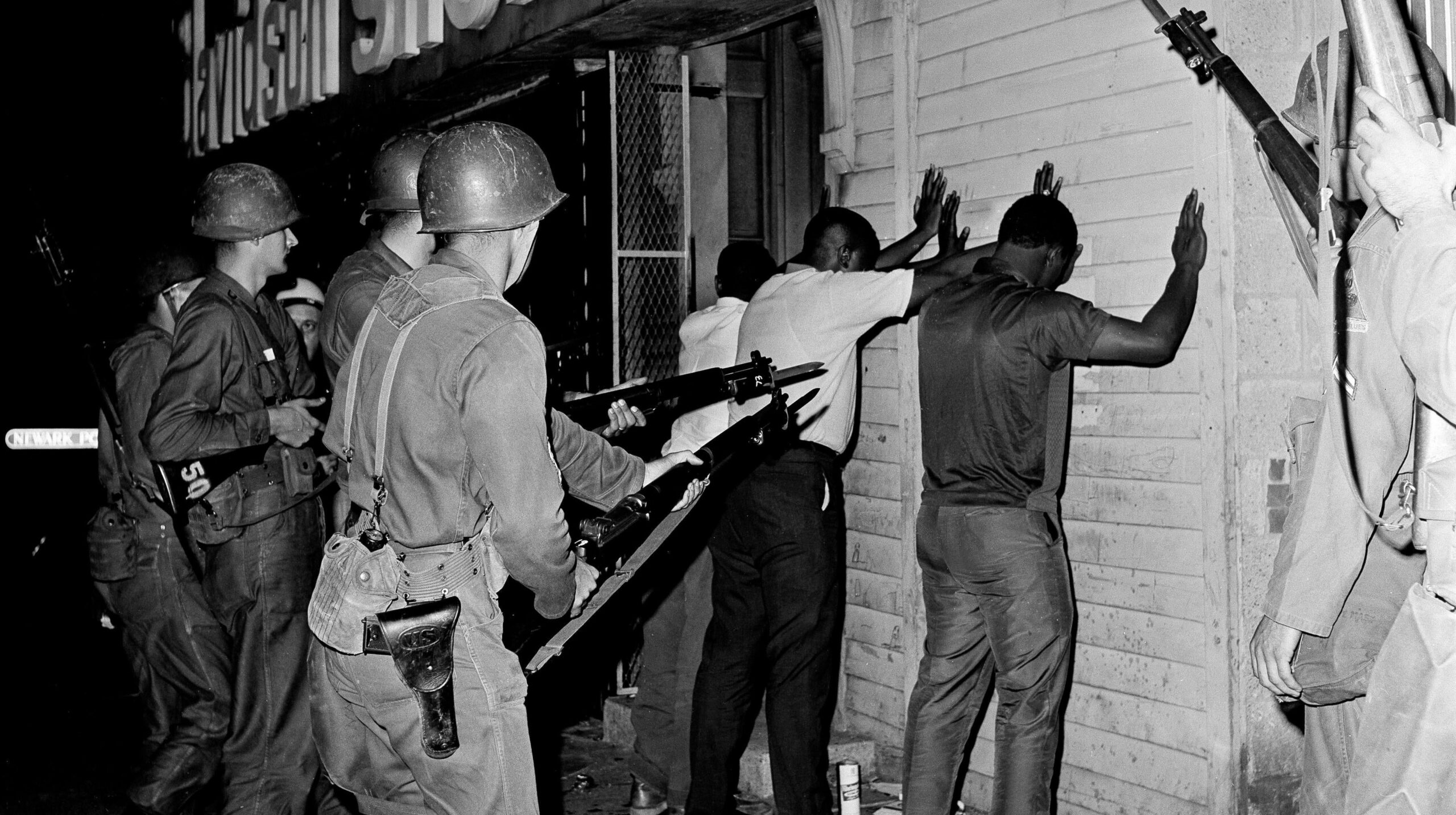 National Guardsmen point bayonets at three men who were arrested, July 14, 1967, in Newark after a 10 p.m. curfew was put into effect by Gov. Richard Hughes. - Associated Press