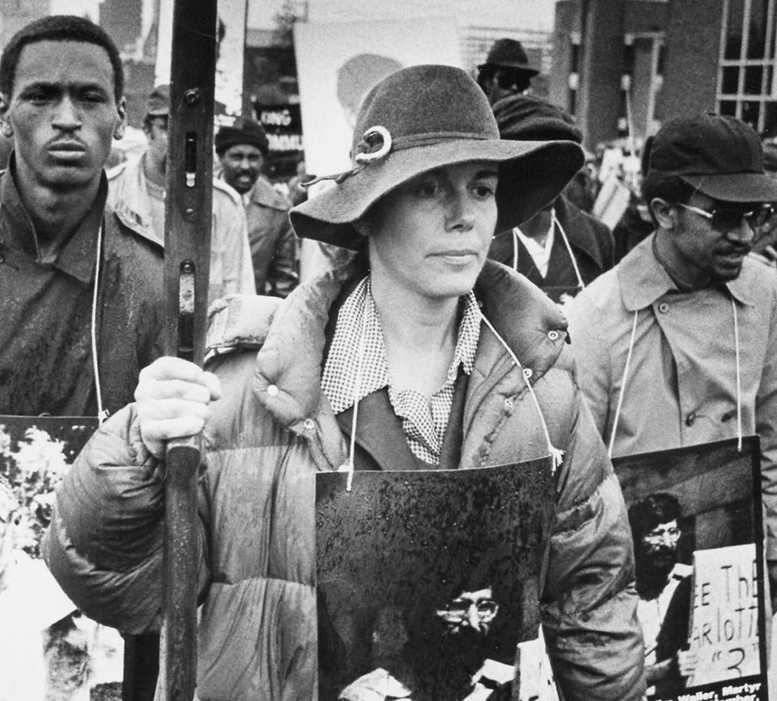 In this Nov. 11, 1979 file photo, Signe Waller leads march in Greensboro, N.C. The state, with the blessing of the Greensboro City Council, will use the word “massacre” for a highway historical marker commemorating the deaths of five Communist Workers Party members during a confrontation with Ku Klux Klansmen and the American Nazi Party. The marker, which will be dedicated Sunday, May 24, 2015. (Jim Stratford /News & Record via AP) - Associated Press
