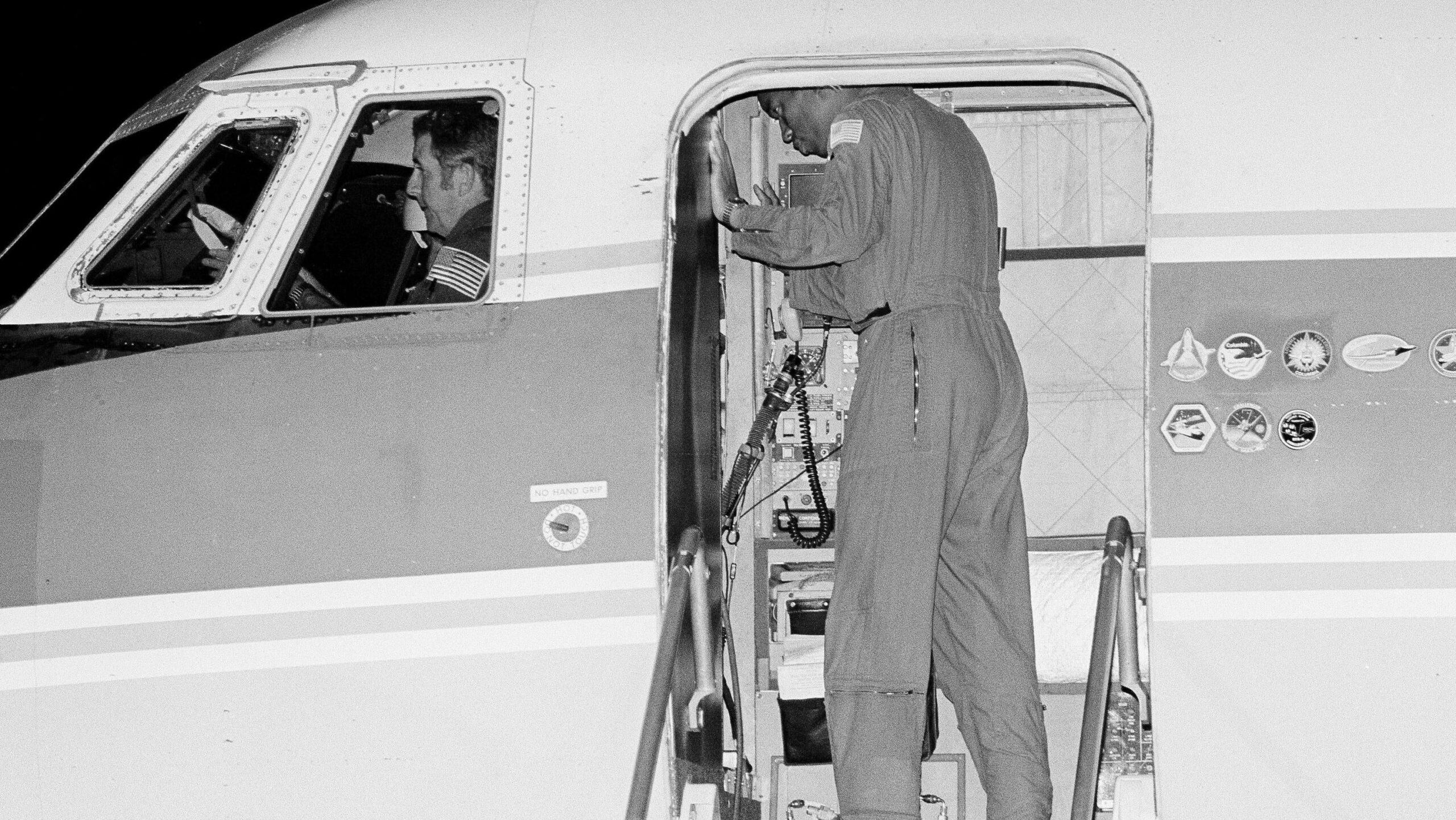 Richard Truly, commander of he Space Shuttle Orbital Flight 8, sits in the cockpit of a Shuttle training vessel during night landing practice at Kennedy Space Center in Fla., Aug. 28, 1983. Standing in the door is Mission Specialist Guion S. Bluford, a member of the STS-8 crew. The Shuttle Challenger is scheduled for an early morning launch on Aug. 30. (AP Photo/Steve Helber) - Associated Press