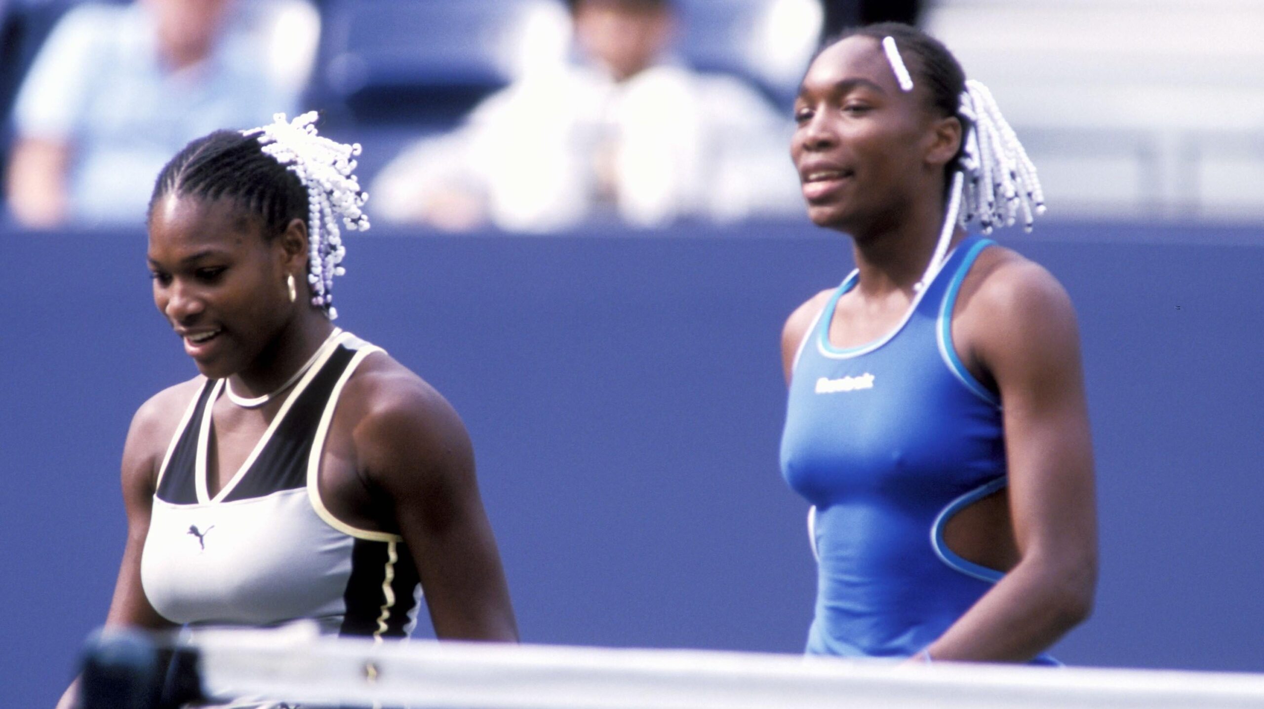 Sisters Venus and Serena Williams compete in women’s doubles at the U.S. Open tennis tournament in 1999. - Associated Press