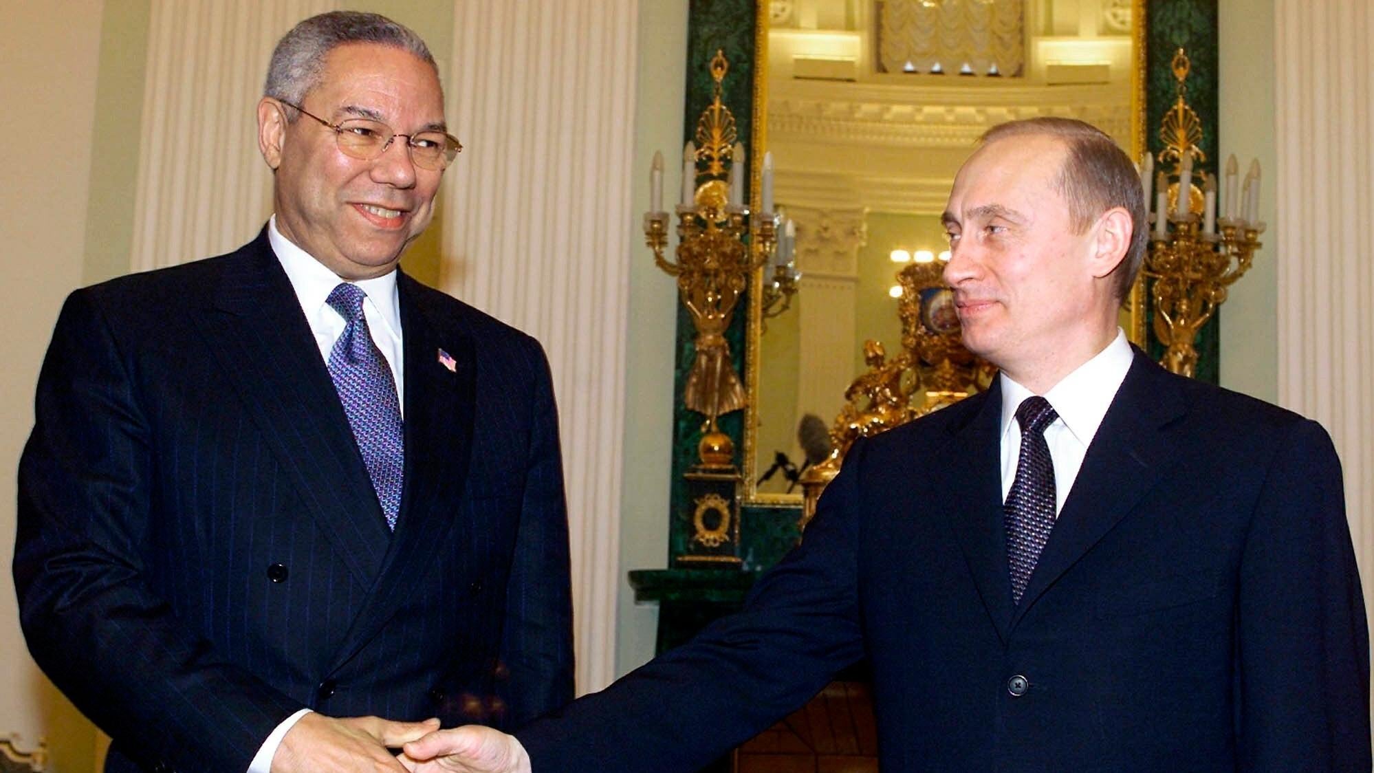 In this file photo taken on Monday, Dec. 10, 2001, Russian President Vladimir Putin, right, and U.S. Secretary of State Colin Powell shake hands during their meeting in the Kremlin in Moscow, Russia. Colin Powell, former Joint Chiefs chairman and secretary of state, has died from COVID-19 complications. In an announcement on social media Monday, Oct.18, 2021, the family said Powell had been fully vaccinated. Powell was the first African American to serve as chairman of the Joint Chiefs of Staff and secretary of state. (Yuri Kadobnov/Pool Photo via AP, File) - Associated Press