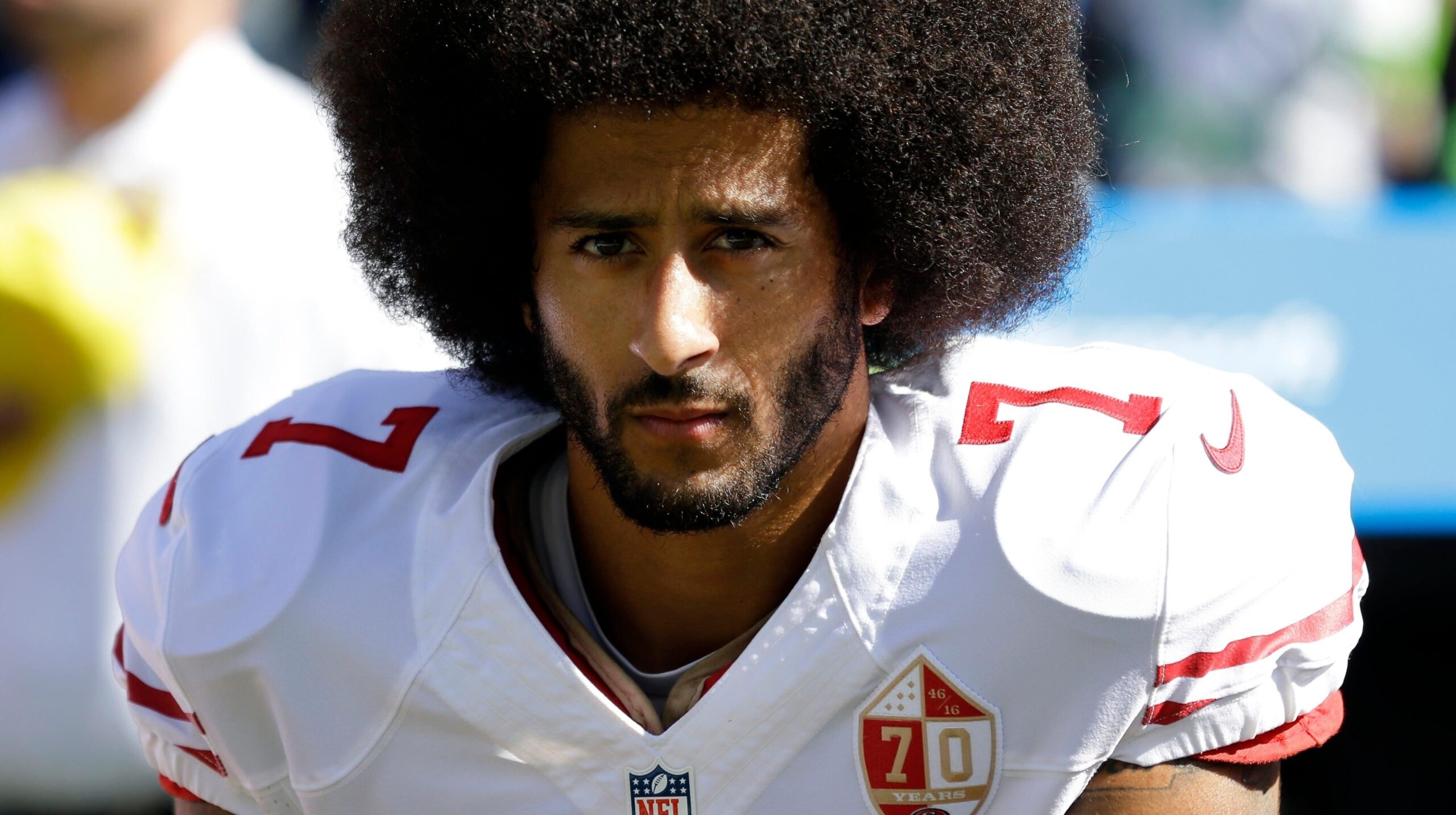 In this Sept. 25, 2016, file photo, San Francisco 49ers quarterback Colin Kaepernick kneels during the national anthem before an NFL football game against the Seattle Seahawks in Seattle. Kaepernick was a second-round draft pick in 2011 who the next year led the San Francisco 49ers to the Super Bowl. By 2016, he had begun kneeling on the sideline at games during the national anthem to protest social injustice and police brutality. Soon after, he was gone from the NFL, and he has not played since. (AP Photo/Ted S. Warren, File) - Associated Press