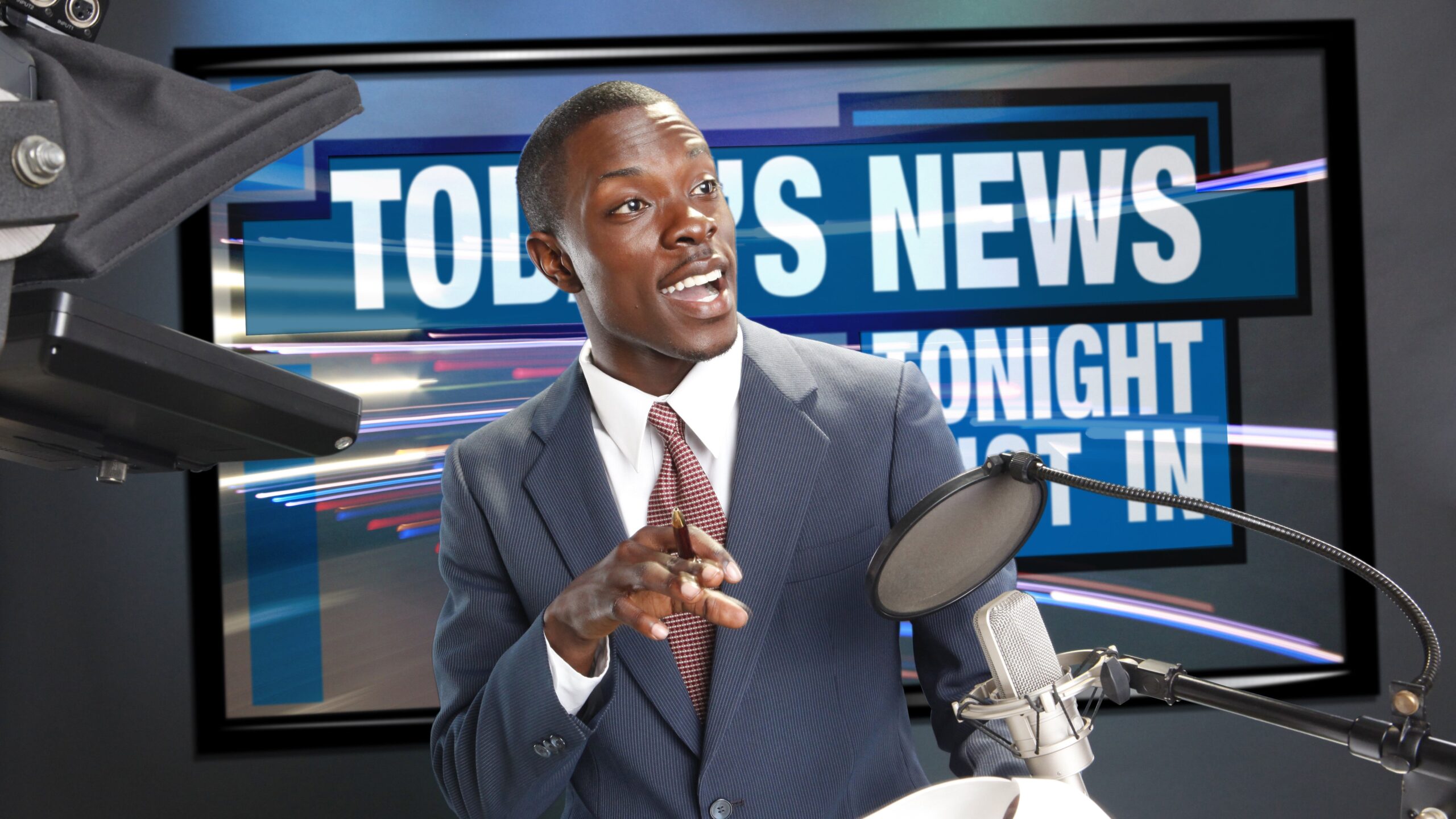 TV/Radio news anchor with prompter and microphone. Photo: Shutterstock Shutterstock
