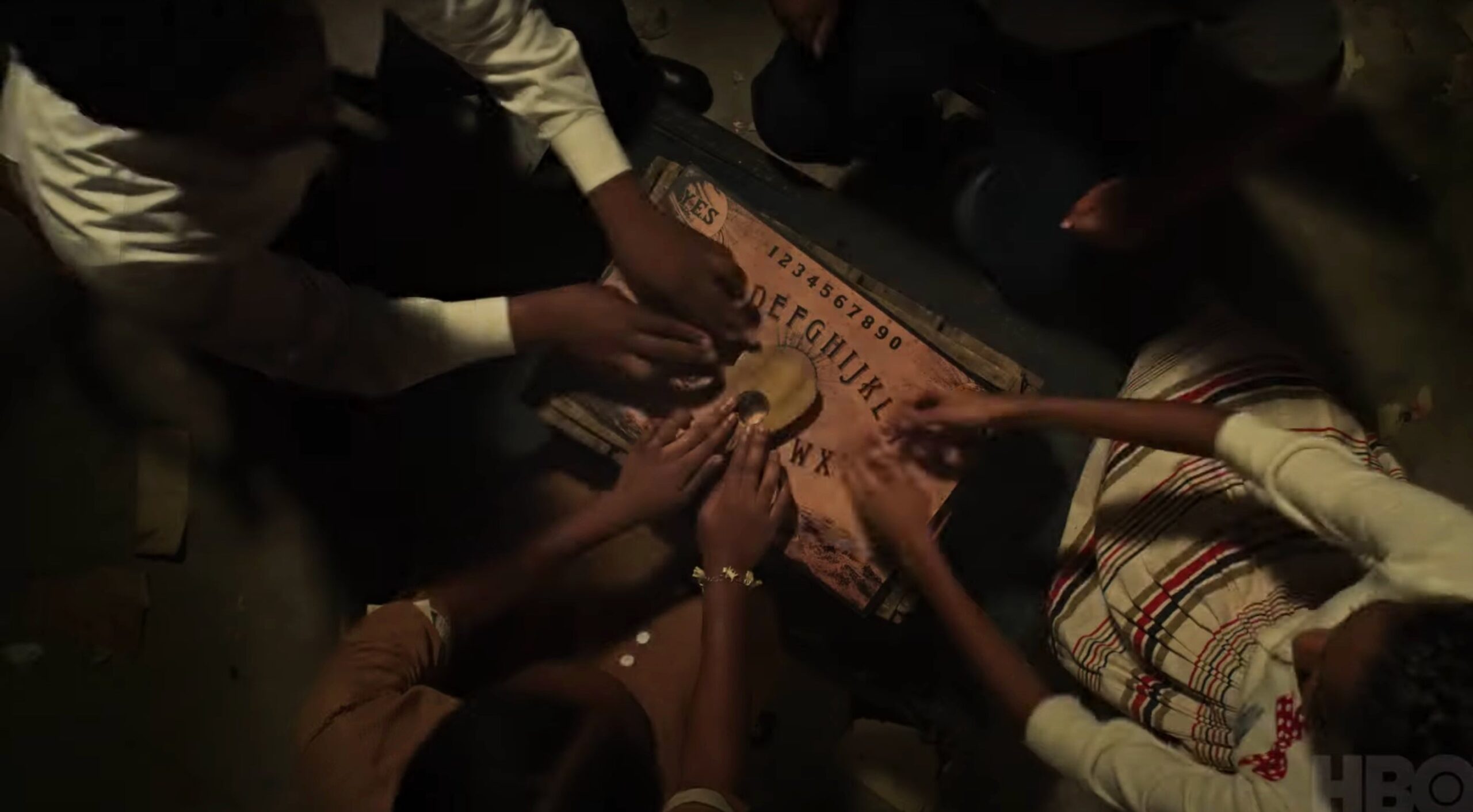 Four youngsters play with a Ouija board in Episode 3 of ‘Lovecraft Country.’ Screenshot: HBO (YouTube